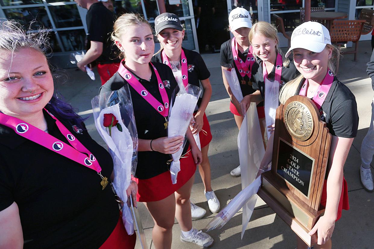 Members of the Gilbert girls' golf team celebrate with their 2024 Class 3A state championship trophy after repeating as state champions with a 3A record score of 608 in 36 holes during the 3A girls' state golf tournament Friday at the golf course. Pheasant Ridge at Cedar Falls.  Iowa.