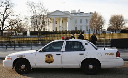 Members of the Secret Service keep watch at the White House in Washington March 12, 2015. REUTERS/Kevin Lamarque