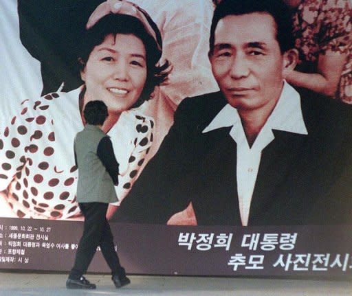 This file photo shows a large picture of former South Korean president Park Chung-Hee and his wife, displayed outside a state hall in Seoul, in 1999, before a photo exhibit commemorating the late dictator. Park is credited with laying the foundations for S.Korea's economic rise, and admirers say his autocratic style was justified by the poverty, security issues and social divisions existing then