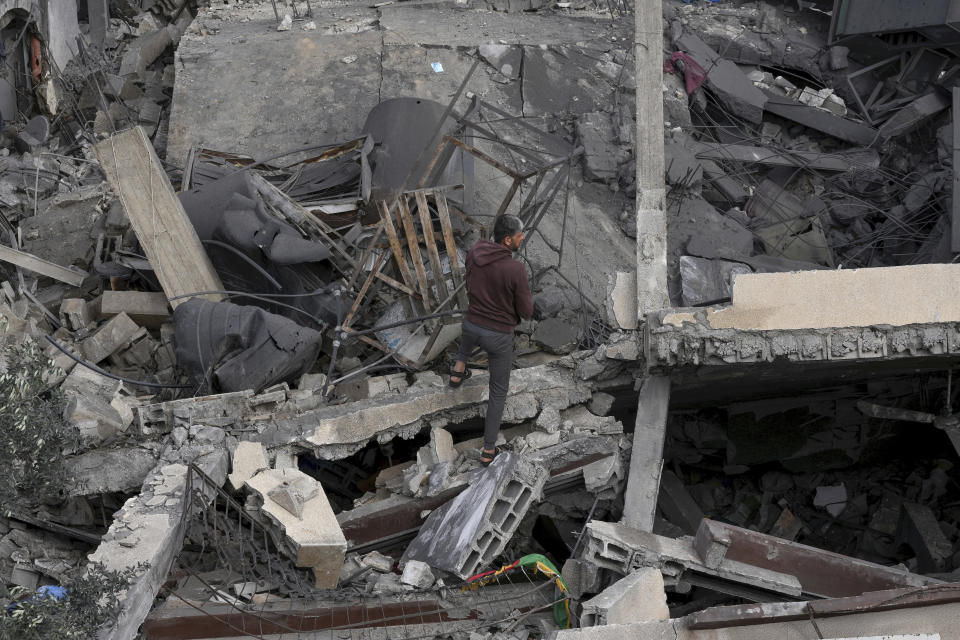 Palestinians inspect the rubble of Islamic Jihad member Anas Al Massri's house after it was hit by an Israeli airstrike last night in Beit Lahiya, northern Gaza Strip, Thursday, May 11, 2023. (AP Photo/Adel Hana)