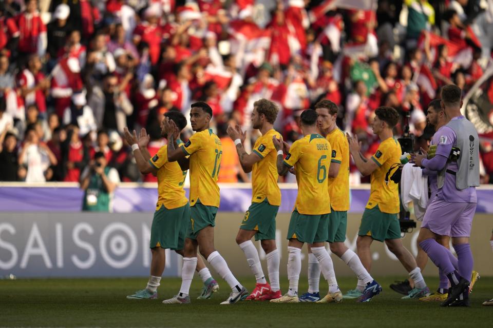 Australian players celebrate after they won the Asian Cup round of 16 soccer match between Australia and Indonesia at Jassim Bin Hamad Stadium in Doha, Qatar, Sunday, Jan. 28, 2024. (AP Photo/Aijaz Rahi)