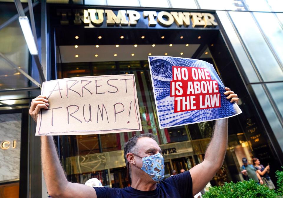 A protester stands in front of Trump Tower in New York