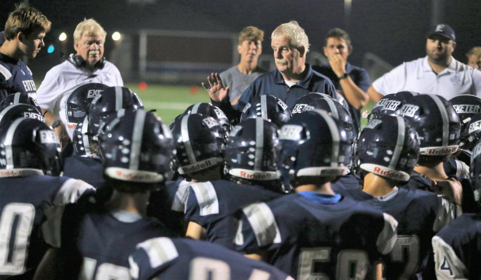 Exeter High School football head coach Bill Ball talks to his team after Friday's 31-7 win over Nashua North.