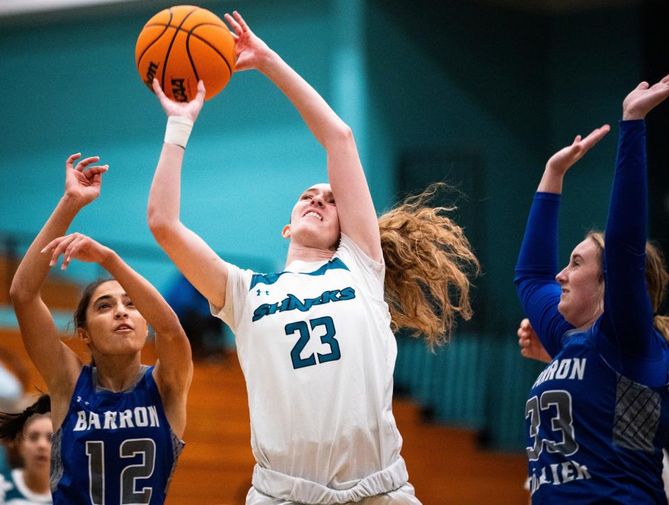 Gulf Coast Sharks forward Lilly Fultz (23) goes for a lay up during the first quarter of a game against the Barron Collier Cougars at Gulf Coast High School in Naples on Tuesday, Dec. 12, 2023.