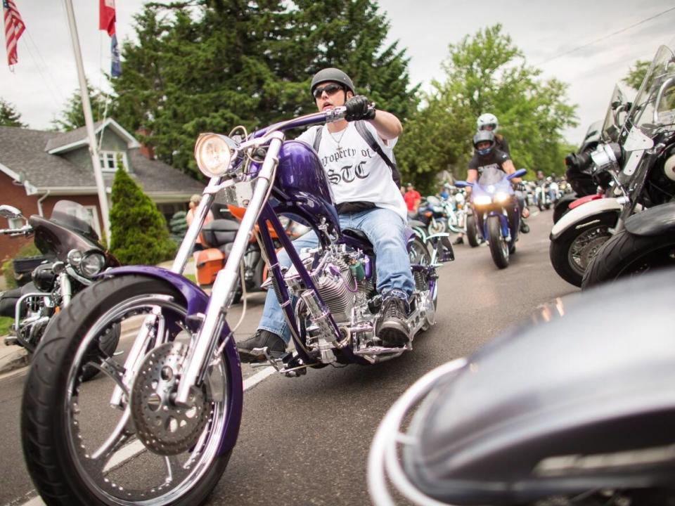 A motorcyclist tours through downtown Port Dover, Ontario, during the town's Friday the 13th celebrations Friday, June 13, 2014. OPP is expecting a large presence this week. (Geoff Robins/Canadian Press - image credit)