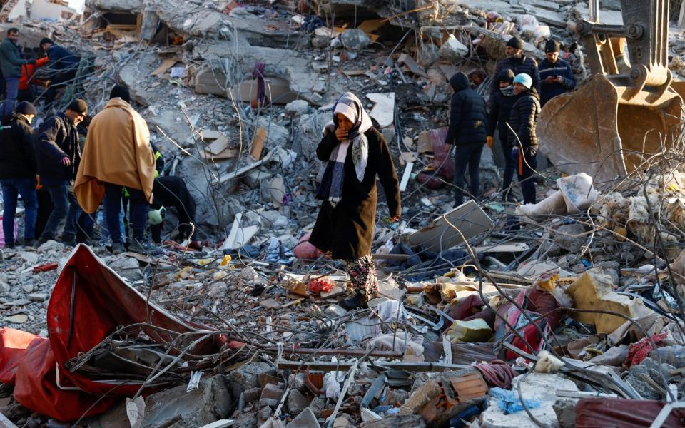 A woman looks at the destruction in Kahramanmaras - REUTERS/Suhaib Salem