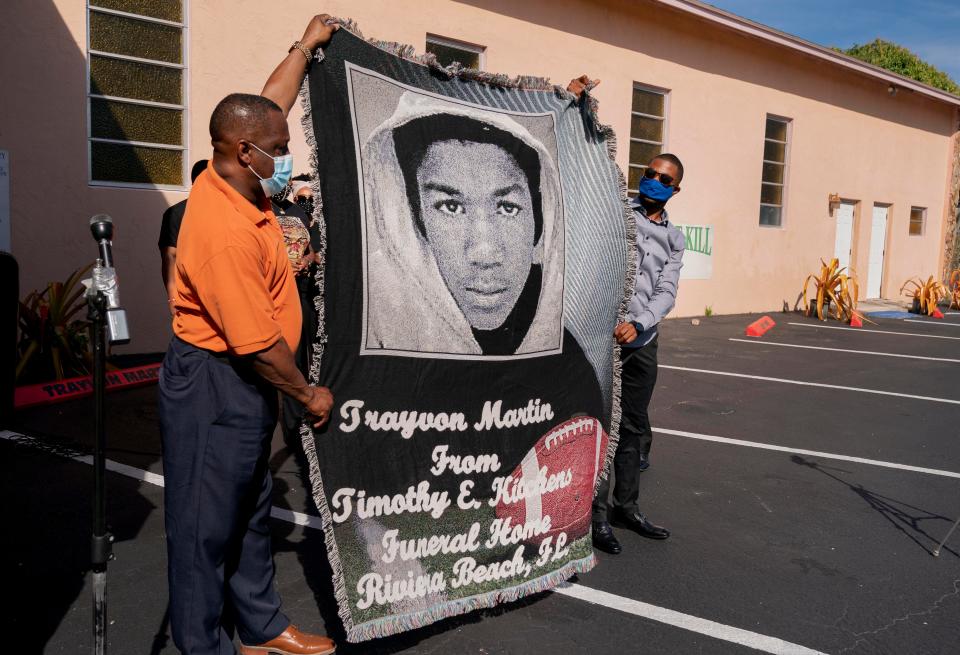 Timothy Kitchens, left, and Bryce Graham presented Sybrina Fulton, mother of Trayvon Martin, with a blanket during her visit to a Black Lives Matter tribute outside the New Macedonia Missionary Baptist Church in Riviera Beach in January 2021.