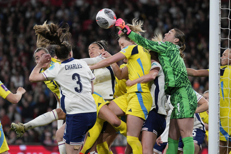 England's goalkeeper Mary Earps, center right, clears the ball during the Euro 2025 group A3 qualifying soccer match between England and Sweden at the Wembley stadium in London, Friday, April 5, 2024. (AP Photo/Dave Shopland)