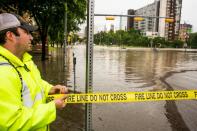 Tape is stretched across a flooded Sixth Street after days of heavy rain on May 25, 2015 in Austin, Texas