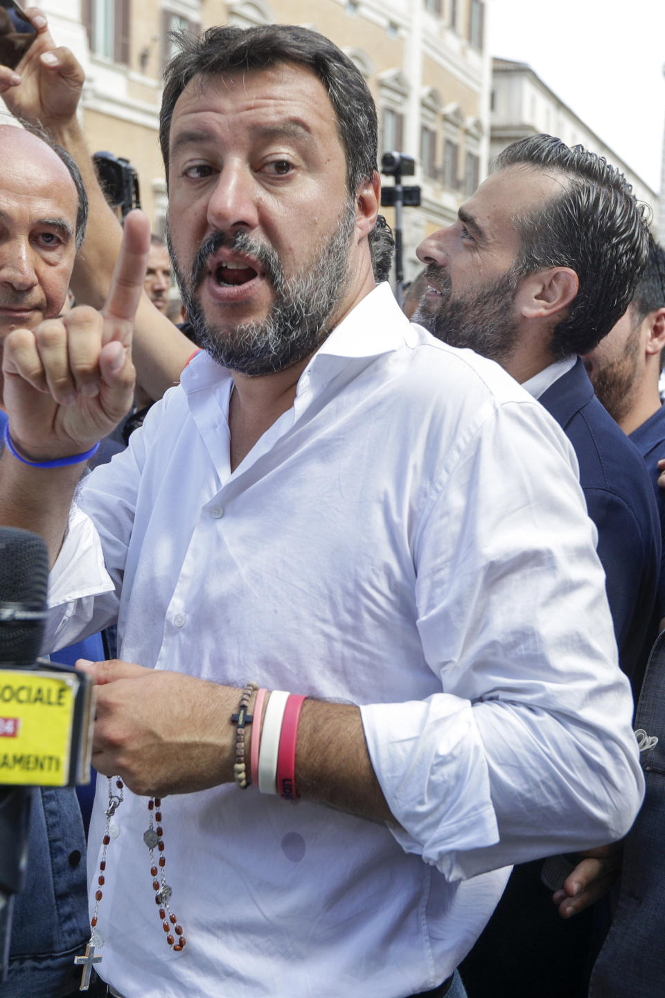 The League's leader Matteo Salvini holds a rosary as he attends a demonstration with far-right party Brothers of Italy against the 5-Star and Democratic party coalition government, in Rome, Monday, Sept. 9, 2019. Italian Premier Giuseppe Conte is pitching for support in Parliament for his new left-leaning coalition ahead of crucial confidence votes. (AP Photo/Andrew Medichini)