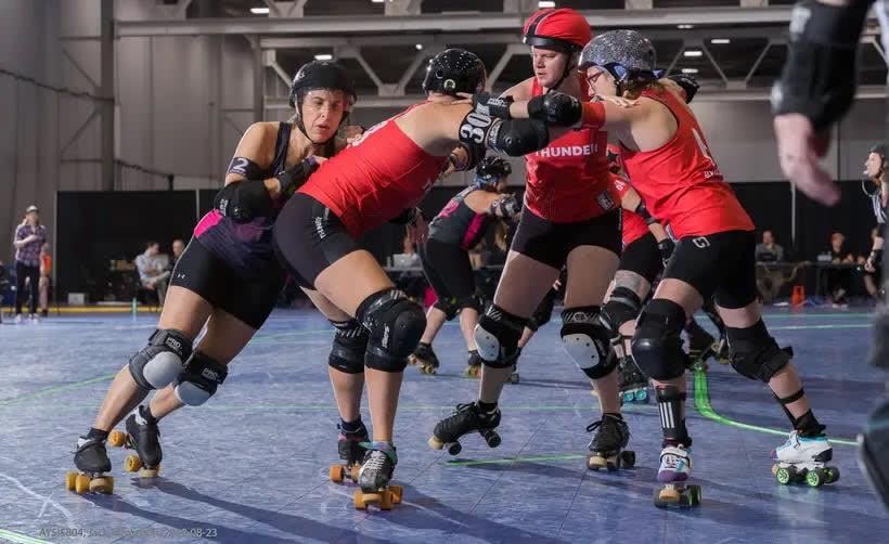 Members of Tri-City Thunder, including Christie Henderson (right) and Jane Hutton, (second from the right), brace against one another. (Buzz and Raider Photography - image credit)