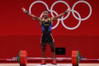 Foto del miércoles del venezolano Julio Mayora reaccionando tras ganar la medalla de plata en halterofilia hasta 73 kilos