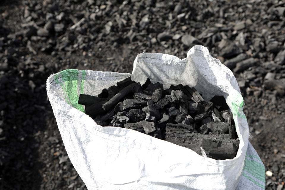A sack of charcoal is filled in Gulu, Uganda on May 27, 2023. Uganda's population explosion has heightened the need for cheap plant-based energy sources, especially charcoal.(AP Photo/Hajarah Nalwadda)