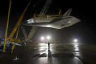 STERLING, VA - APRIL 19: In this handout provided by NASA, the space shuttle Discovery is suspended from a sling held by two cranes shortly after the NASA 747 Shuttle Carrier Aircraft (SCA) was pushed back from underneath at Washington Dulles International Airport on April 19, 2012, in Sterling, Virginia. Discovery, the first orbiter retired from NASA's shuttle fleet, completed 39 missions, spent 365 days in space, orbited the Earth 5,830 times, and traveled 148,221,675 miles. NASA will transfer Discovery to the National Air and Space Museum to begin its new mission to commemorate past achievements in space and to educate and inspire future generations of explorers. (Photo by NASA/Bill Ingalls via Getty Images)