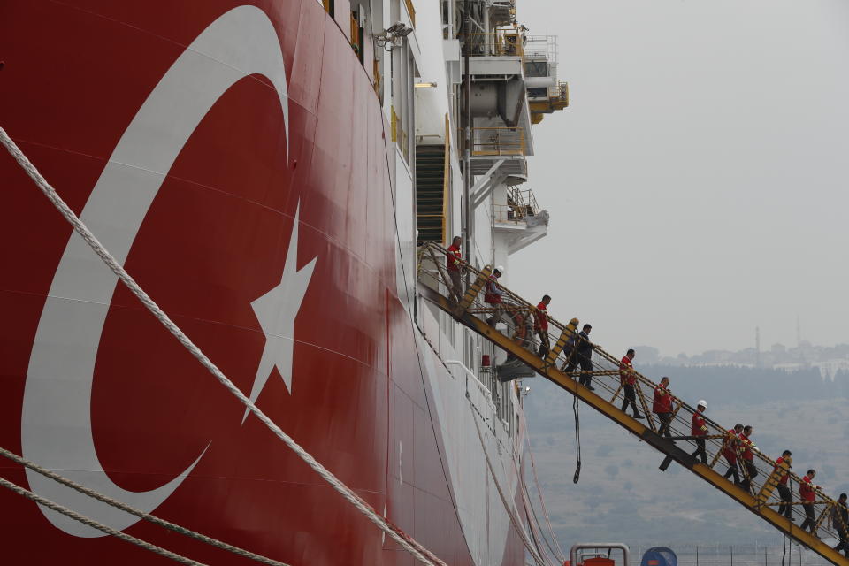 Members of the press and officials on a tour, disembark the drillship 'Yavuz' scheduled to be dispatched to the Mediterranean, at the port of Dilovasi, outside Istanbul, Thursday, June 20, 2019. Turkish officials say the drillship Yavuz will be dispatched to an area off Cyprus to drill for gas. The Cyprus government says Turkey’s actions contravene international law and violate Cypriot sovereign rights. (AP Photo/Lefteris Pitarakis)