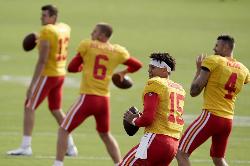 Kansas City Chiefs quarterbacks Dustin Crum (13), Shane Buechele (6), Patrick Mahomes (15) and Chad Henne (4) participate in a drill during NFL football training camp Sunday, Aug. 7, 2022, in St. Joseph, Mo. (AP Photo/Charlie Riedel)