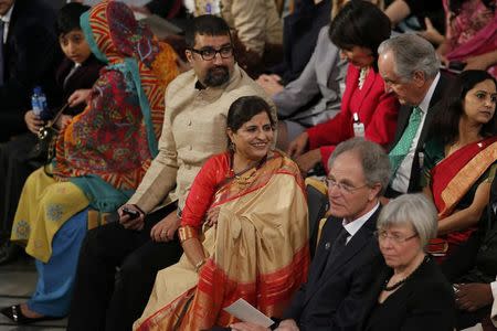 Sumedha (C), wife of Indian childrens right activist and 2014 Nobel peace prize laureate Kailash Satyarthi, and their son (3rd L) attend the Nobel Peace Prize awards ceremony at the City Hall in Oslo December 10, 2014. REUTERS/Suzanne Plunkett
