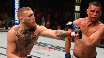 Conor McGregor lands a punch on Nate Diaz during their UFC 196 bout. (Getty)