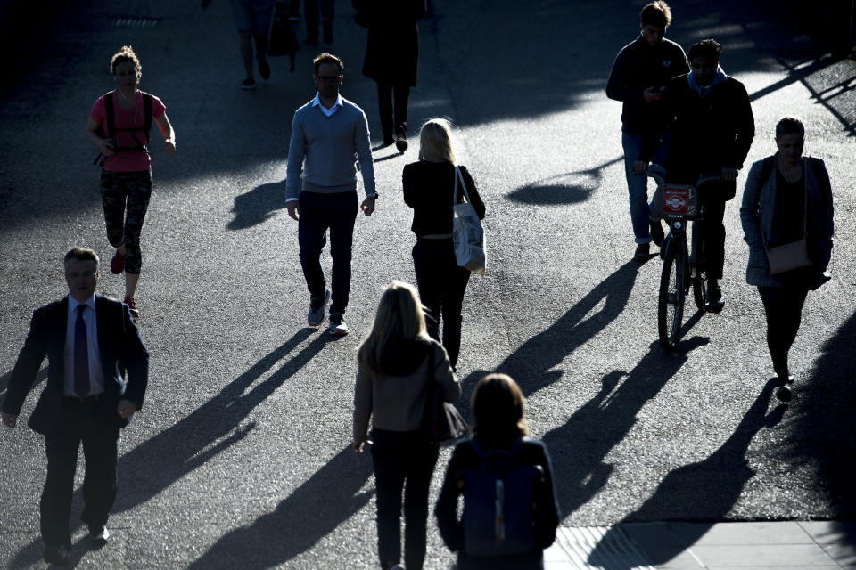 Commuters silhouetted in early morning sunlight as they walk along the southern bank of the River Thames in central London as Storm Aileen brought howling gusts and heavy showers to parts of the UK.