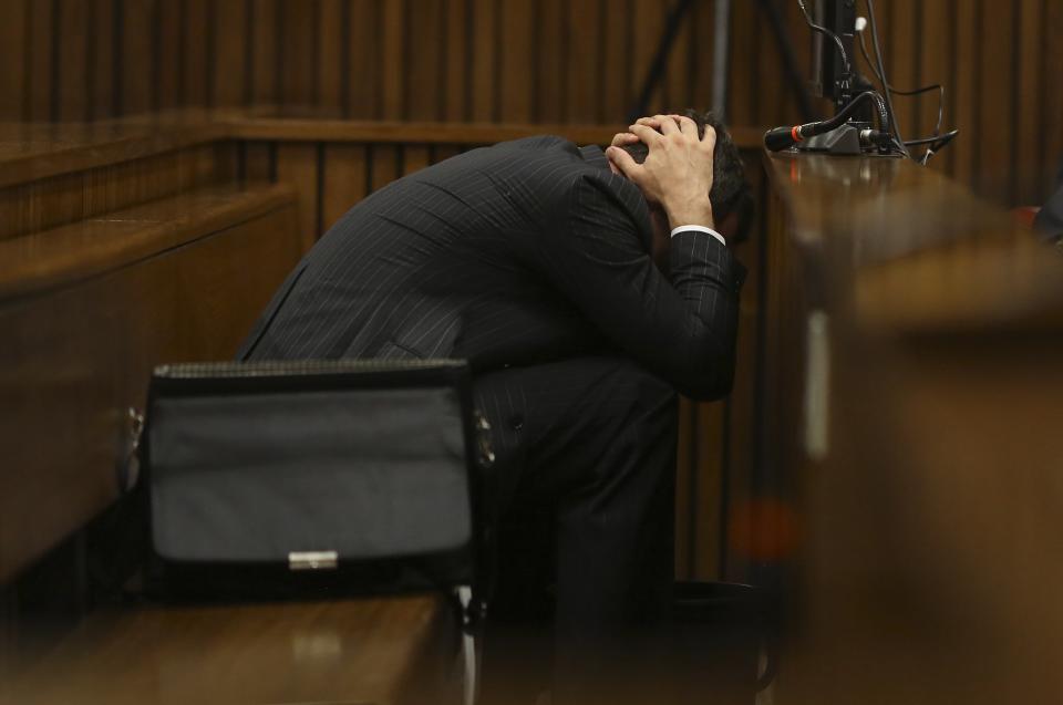 Olympic and Paralympic track star Oscar Pistorius reacts in the dock during his trial for the murder of his girlfriend Reeva Steenkamp, at the North Gauteng High Court in Pretoria, March 10, 2014. Pistorius broke down on Monday when a South African court heard details from the autopsy of girlfriend Reeva Steenkamp, whom the track star is accused of murdering on Valentine's Day last year. REUTERS/Siphiwe Sibeko (SOUTH AFRICA - Tags: SPORT ATHLETICS CRIME LAW)
