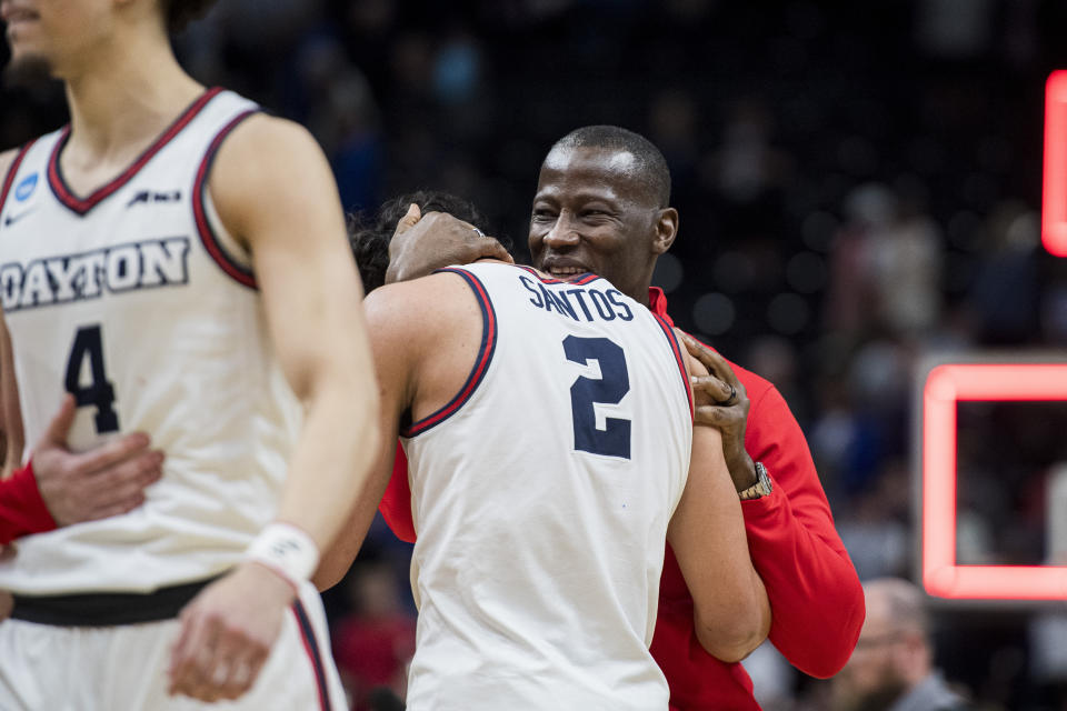 Dayton head coach Anthony Grant, right, hugs Dayton forward Nate Santos (2) as they celebrate after their team's victory over Nevada in a first-round college basketball game in the NCAA Tournament in Salt Lake City, Thursday, March 21, 2024. (AP Photo/Isaac Hale)