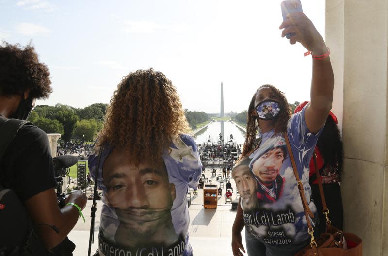 Laurie Bey, right, whose son Cameron Lamb was shot and killed by Kansas City police in 2019, makes final preparations to participate in the March on Washington in Washington DC on Aug. 28, 2020. (AP)