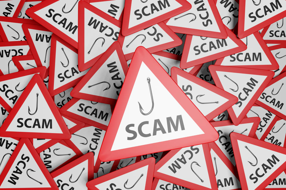 Pile of 'SCAM' warning signs with a fishing hook symbol, depicting dangers of financial fraud