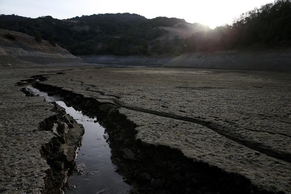 A stream of water cuts through the dry bottom of the Almaden Reservoir on January 28, 2014 in San Jose, Calif.