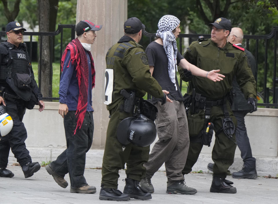 Police remove two protesters as security clears the pro-Palestinian encampment at McGill University in Montreal, Wednesday, July 10, 2024. (Ryan Remiorz/The Canadian Press via AP)