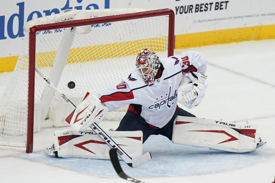 Washington Capitals goaltender Ilya Samsonov gives up a goal to New Jersey Devils' Travis Zajac during the third period of an NHL hockey game Sunday, April 4, 2021, in Newark, N.J. (AP Photo/Frank Franklin II)