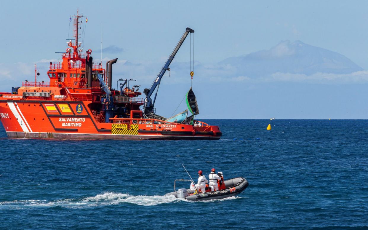 Spanish Sea Rescue services carry some boats after rescuing migrants at sea to Arguineguin, Canary Islands, Spain - Shutterstock