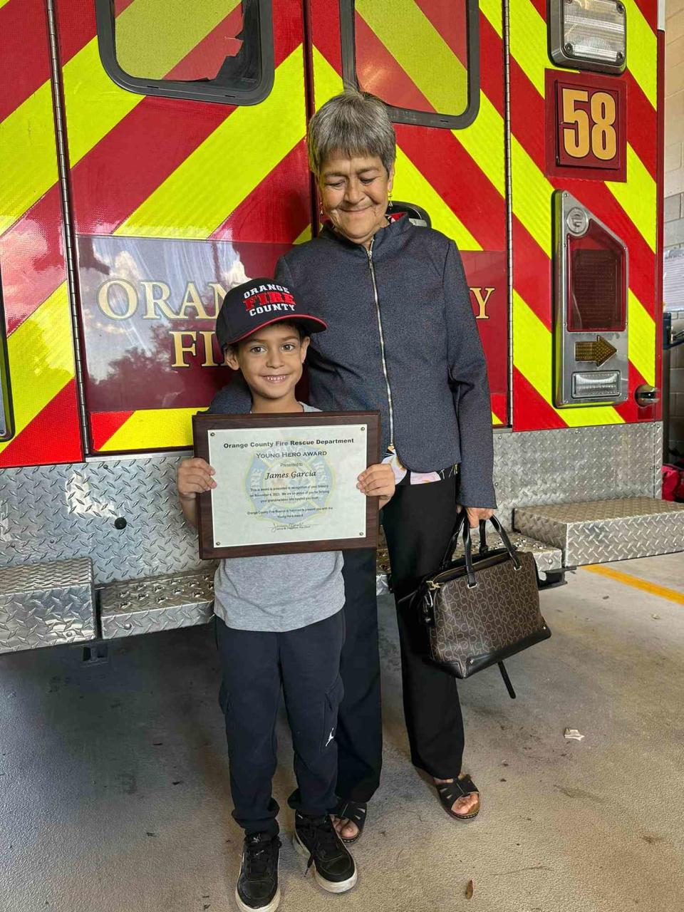 <p>Orange County Fire Rescue Department, Florida/Facebook</p> James Garcia poses with his grandmother Rosa Garcia