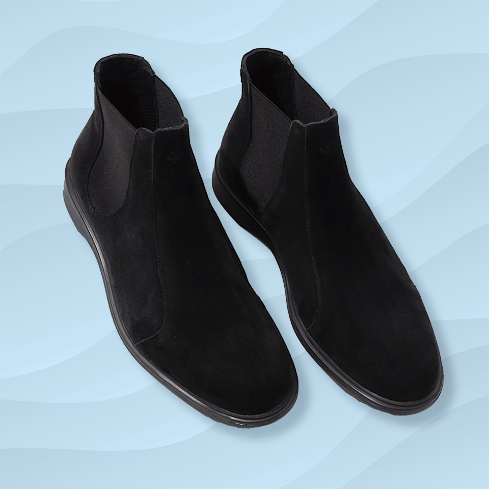 the amberjack black suede chelsea boot against a wavy blue background