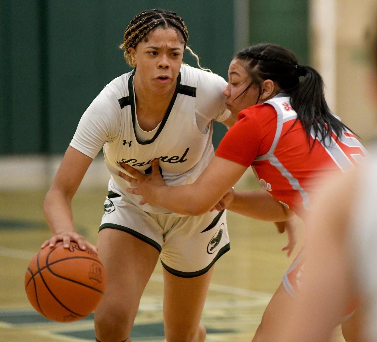 Canton South's Summer Hastings-Peterson tries to contain Laurel standout Saniyah Hall in the third quarter of OHSAA Division II District Semifinals at Nordonia High School. Wednesday, February 28, 2024.