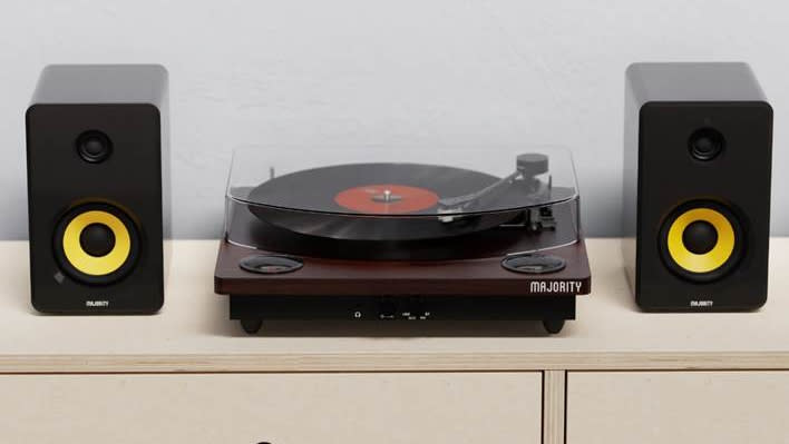  Majority Moto Bluetooth turntable flanked by black and yellow speakers . 