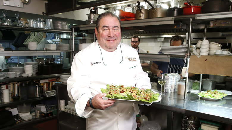 Emeril Lagasse holding tray of food