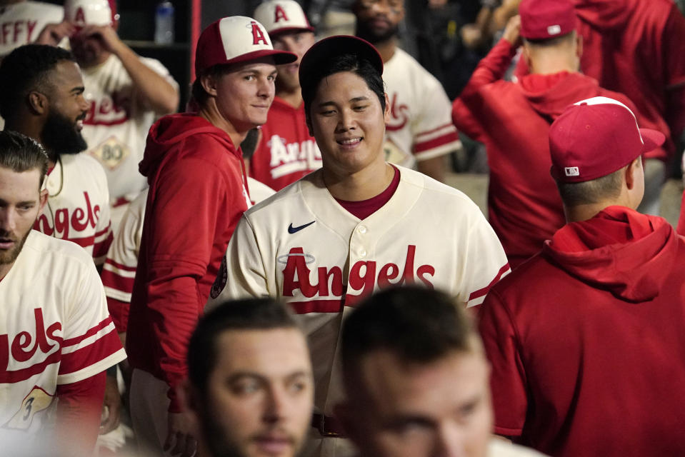 Los Angeles Angels' Shohei Ohtani walks through the dugout after pitching in the eighth inning of a baseball game against the Oakland Athletics Thursday, Sept. 29, 2022, in Anaheim, Calif. (AP Photo/Mark J. Terrill)