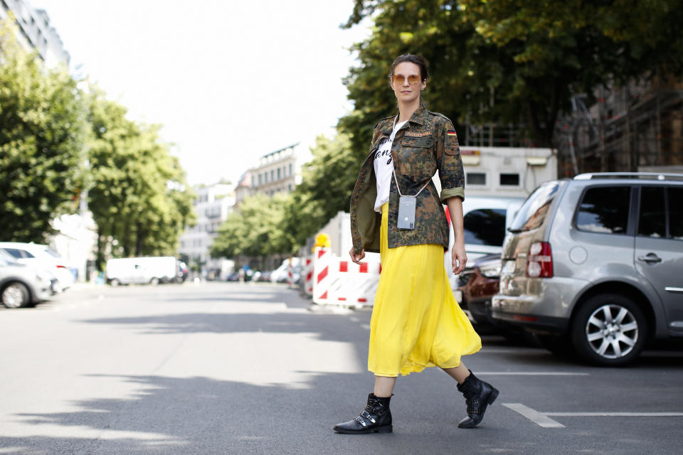 BERLIN, GERMANY - JUNE 16: Actress and TV host Katrin Wrobel wearing a yellow midi skirt by Madeleine, black boots by Shoemates, a camouflage military jacket by Fucking Karma, a white t-shirt by Ohnegleichen and sunglasses by Flair during a street style shooting on June 16, 2020 in Berlin, Germany. (Photo by Streetstyleshooters/Getty Images)