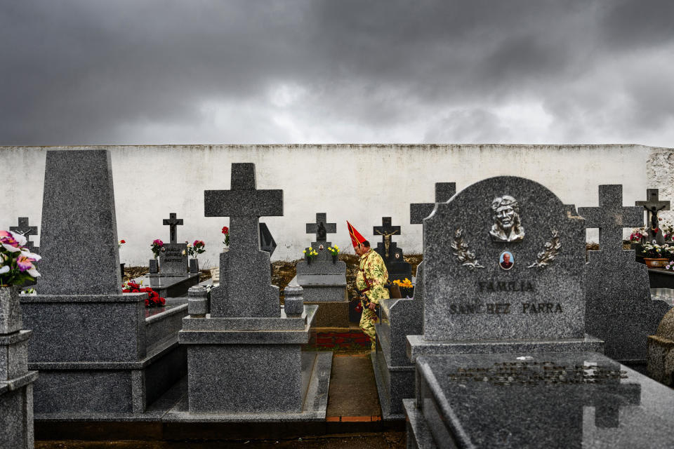 <p>A member of the Endiablada brotherhood walks in a cemetery to pray for the deceased fellow believers and relatives during a traditional festival in Almonacid del Marquesado, Spain, Feb. 2, 2017. (Photo: Daniel Ochoa de Olza/AP) </p>