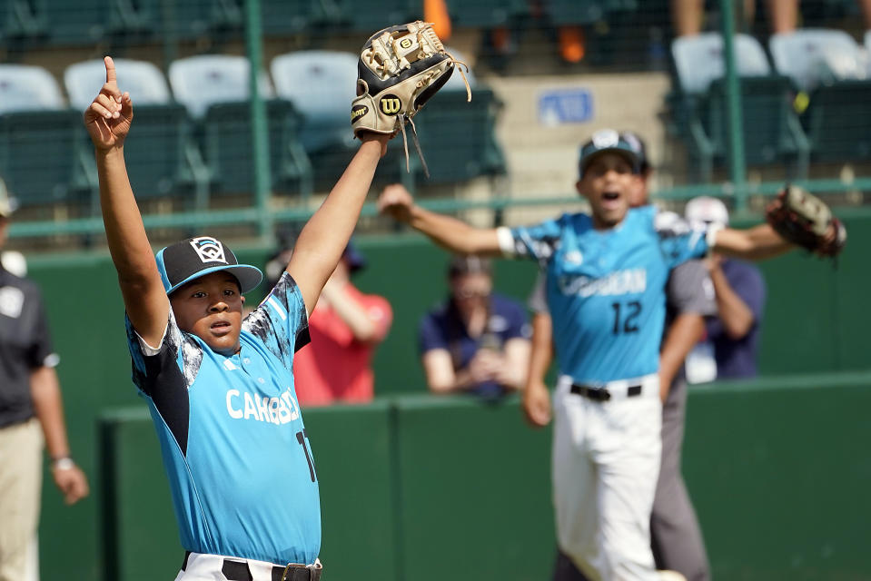 Curacao pitcher Jay-Dlynn Wiel celebrates along with Sean Serverie (12) as the final out is made at first base on Taiwan's Liu You-An (18) during the sixth inning of their 2-0- win in the International Championship baseball game at the Little League World Series tournament in South Williamsport, Pa., Saturday, Aug. 26, 2023. (AP Photo/Tom E. Puskar)