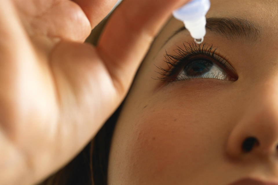 Close-up of a person using eye drops to moisturize their eye