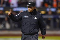 umpire Alfonso Marquez (72) motions to the New York Mets dugout after checking San Diego Padres starting pitcher Joe Musgrove for substances during the sixth inning of Game 3 of a National League wild-card baseball playoff series, Sunday, Oct. 9, 2022, in New York. (AP Photo/Frank Franklin II)