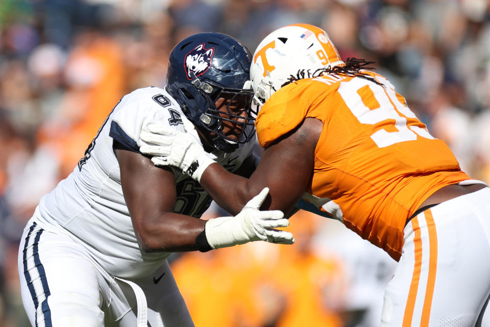 KNOXVILLE, TENNESSEE – NOVEMBER 04: Christian Haynes #64 of the Connecticut Huskies goes head to head against Kurott Garland #99 of the Tennessee Volunteers at Neyland Stadium on November 04, 2023 in Knoxville, <a class="link " href="https://sports.yahoo.com/nfl/teams/tennessee/" data-i13n="sec:content-canvas;subsec:anchor_text;elm:context_link" data-ylk="slk:Tennessee;sec:content-canvas;subsec:anchor_text;elm:context_link;itc:0">Tennessee</a>. Tennessee won the game 59-3. (Photo by Donald Page/Getty Images)