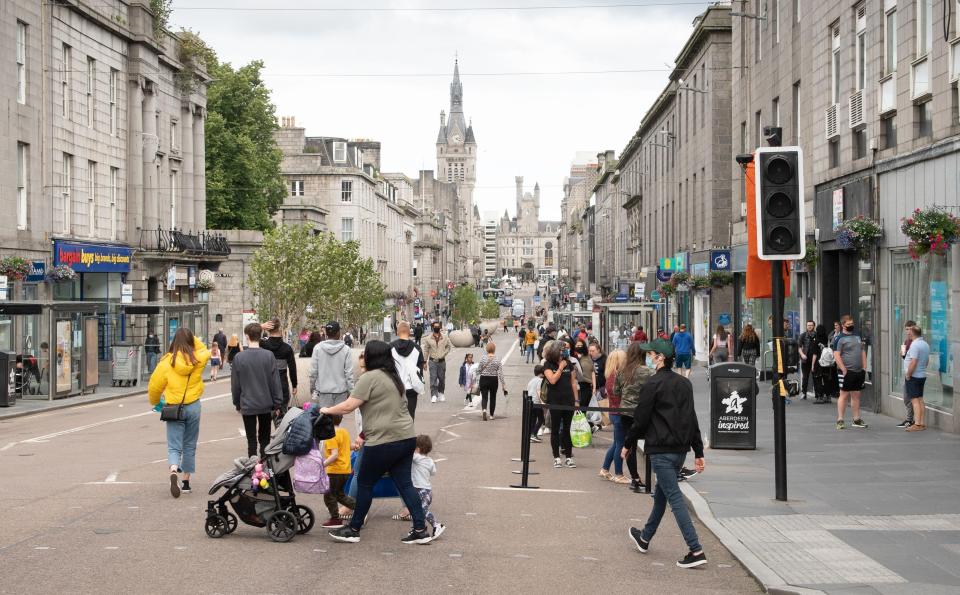 Residents walk in central in Aberdeen, eastern Scotland on August 5, 2020 following the announcement that a local lockdown has been imposed on the city after a spike in the number of cases of novel coronavirus COVID-19. - Scotland will reimpose lockdown restrictions in and around the city of Aberdeen after recording dozens of new coronavirus cases there this week, First Minister Nicola Sturgeon said today. (Photo by Michal Wachucik / AFP) (Photo by MICHAL WACHUCIK/AFP via Getty Images)