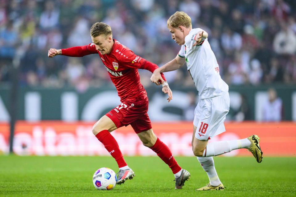 Stuttgart's Chris Fuhrich, left, and Augsburg's Tim Breithaupt in action during the Bundesliga soccer match between FC Augsburg and VfB Stuttgart at WWK-Arena, Augsburg, Germany, Friday May 10, 2024. (Tom Weller/dpa via AP)