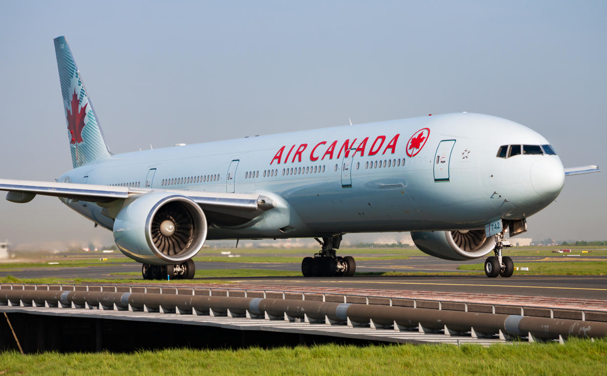 Paris / France - April 24, 2015: Air Canada Boeing 777-300ER C-FIVS passenger plane arrival and landing at Paris Charles de Gaulle Airport