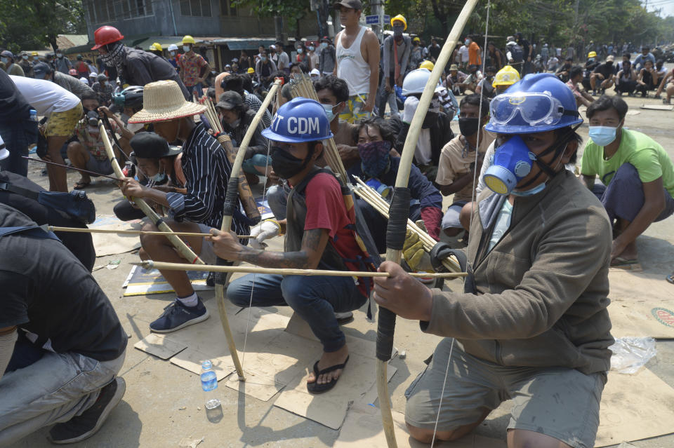 Anti-coup protesters prepare makeshift bow and arrows to confront police in Thaketa township Yangon, Myanmar, Saturday, March 27, 2021. The head of Myanmar’s junta on Saturday used the occasion of the country’s Armed Forces Day to try to justify the overthrow of the elected government of Aung San Suu Kyi, as protesters marked the holiday by calling for even bigger demonstrations. (AP Photo)