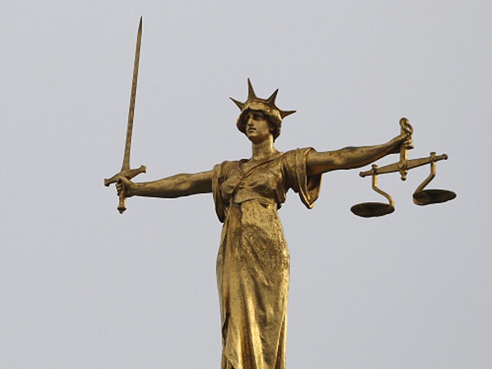 A statue of the scales of justice stands above the Old Bailey (Dan Kitwood/Getty Images)