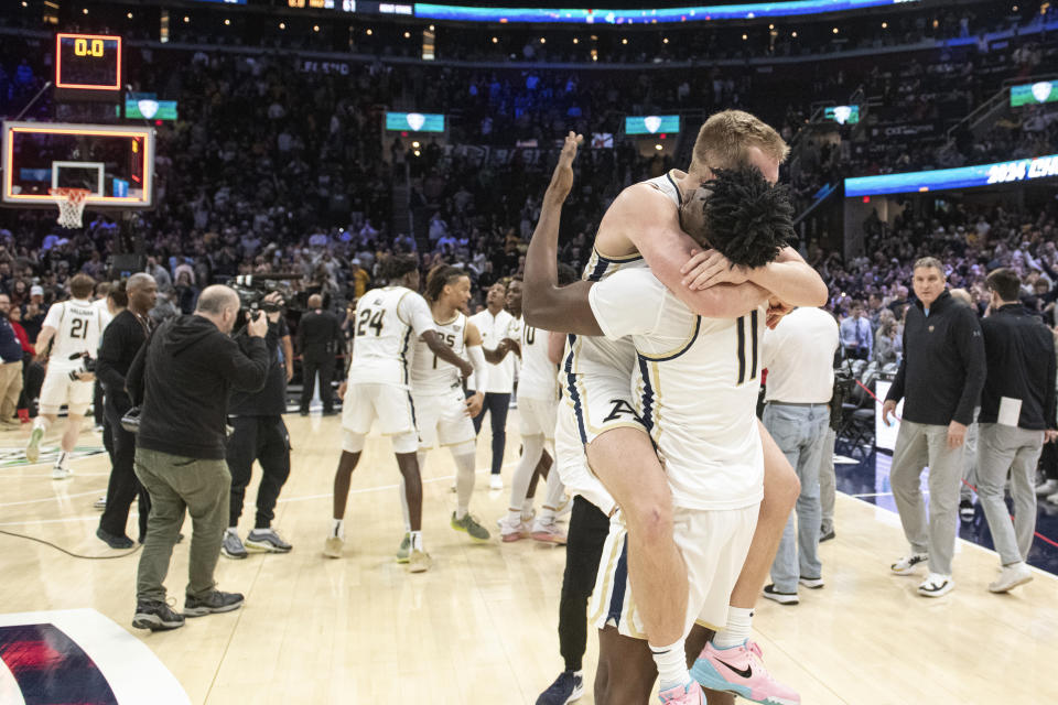 Akron's Sammy Hunter (11) and Akron's Evan Wilson celebrate their victory over Kent State at the end of an NCAA college basketball game in the championship of the Mid-American Conference tournament, Saturday, March 16, 2024, in Cleveland. (AP Photo/Phil Long)