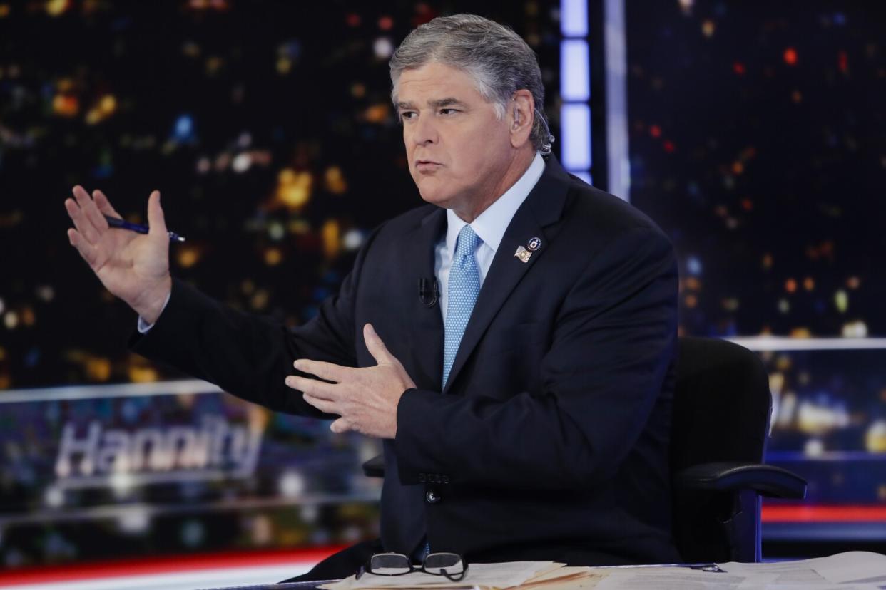 Sean Hannity gestures while speaking during a taping of his show